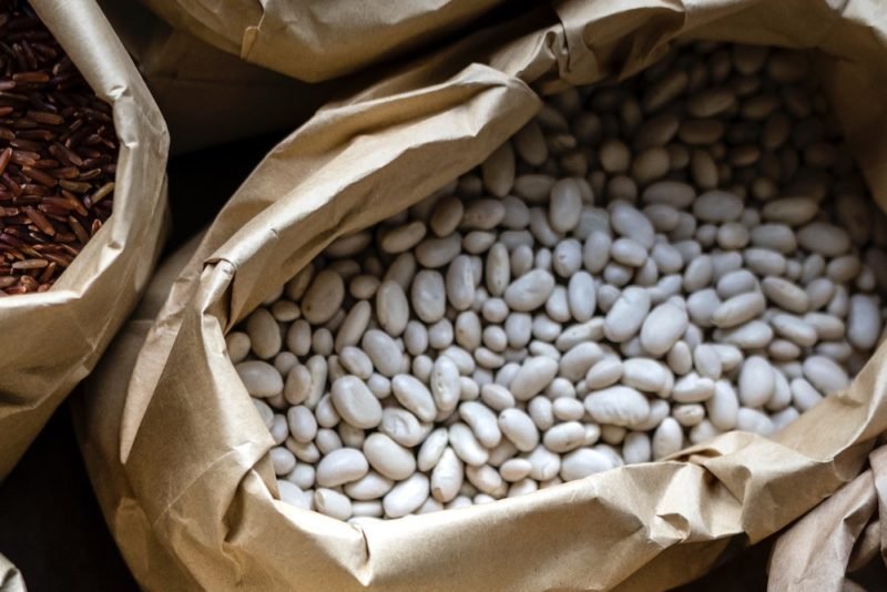 White beans. Photo of a large brown bag of white beans.