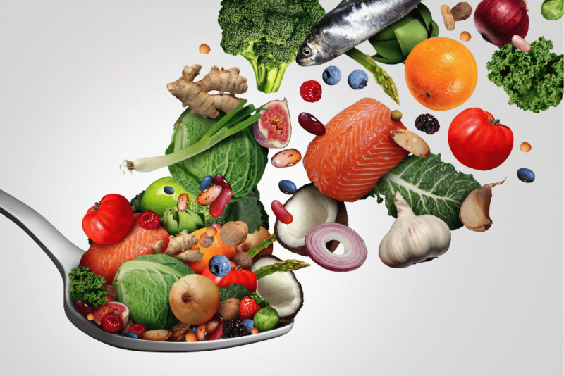 Image of healthy foods that might be considered optimal nutrition, including fruit, vegetables, fish and nuts