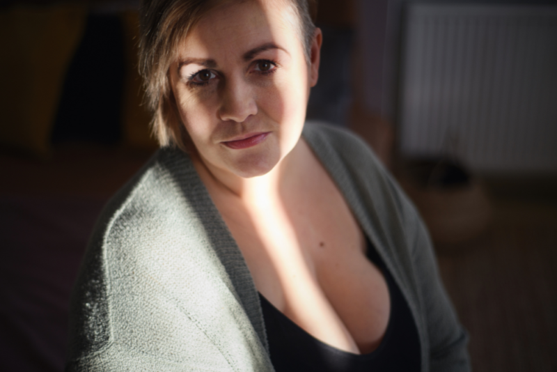 A woman reflecting on her relationship with food, representing the hidden struggles of atypical anorexia and eating disorders in larger bodies.